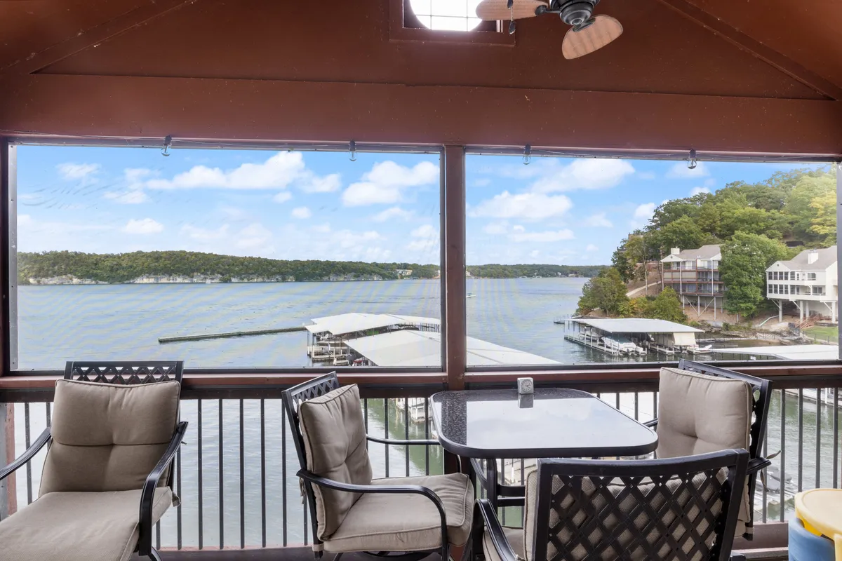 An inviting outdoor seating area with a table overlooks the expansive lake, perfect for relaxing, dining, or socializing while enjoying panoramic water views. The scene radiates serenity and leisure, with the lake as the star feature.